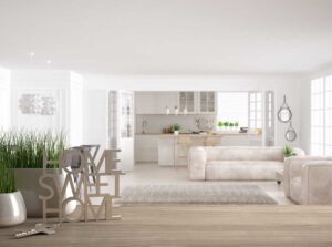 A family packing household boxes together in a bright, lived-in living room.